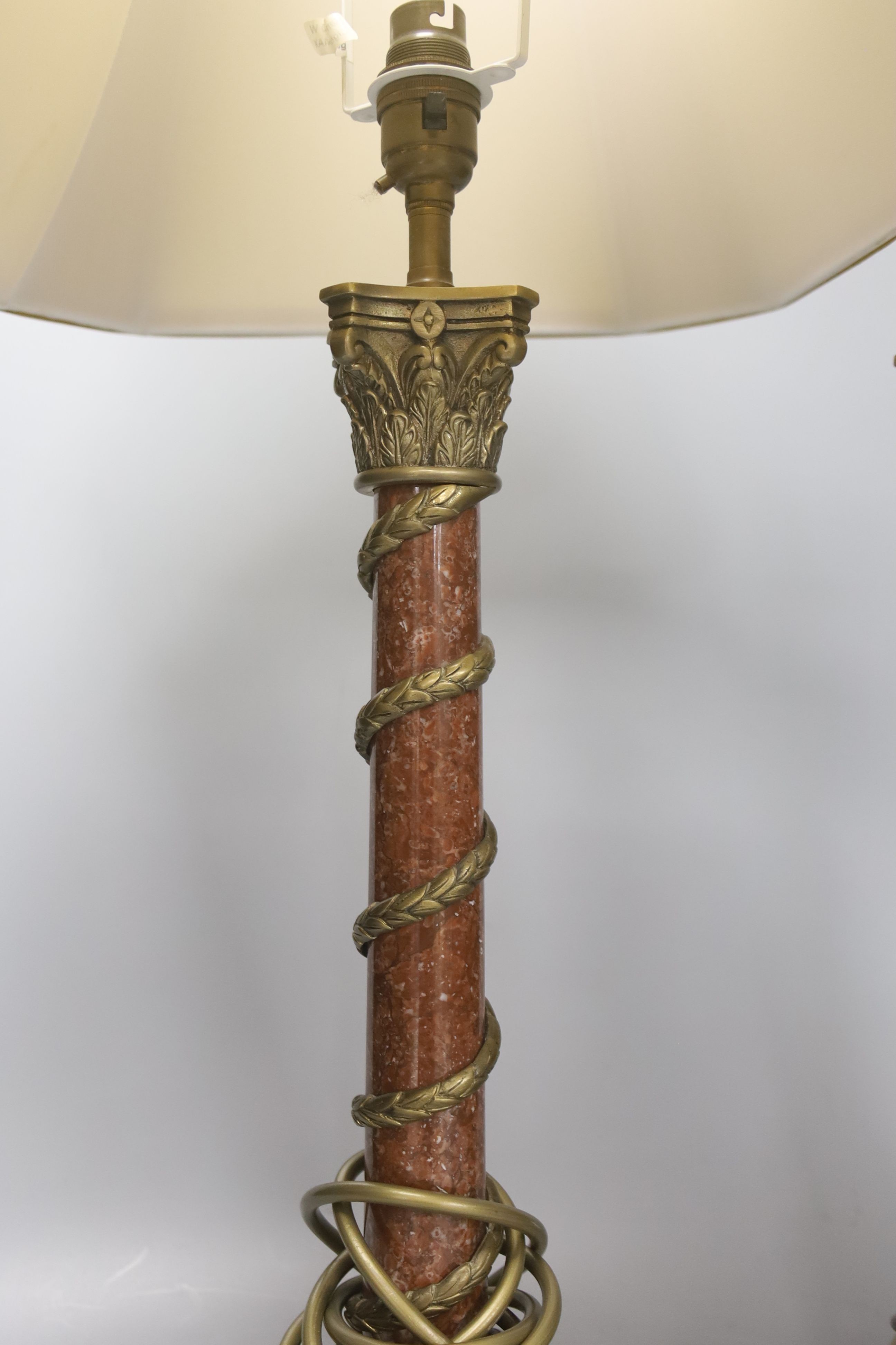 A pair of rouge marble and gilt metal corinthian column table lamps